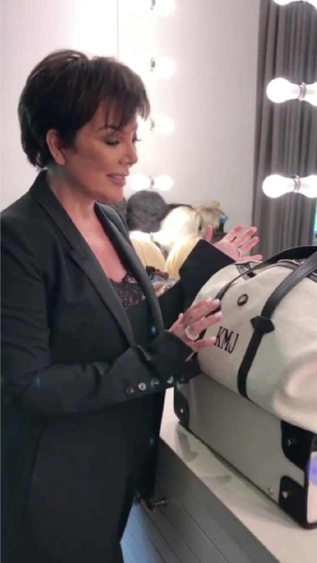 Kris Jenner backstage with a monogrammed Paravel weekender.